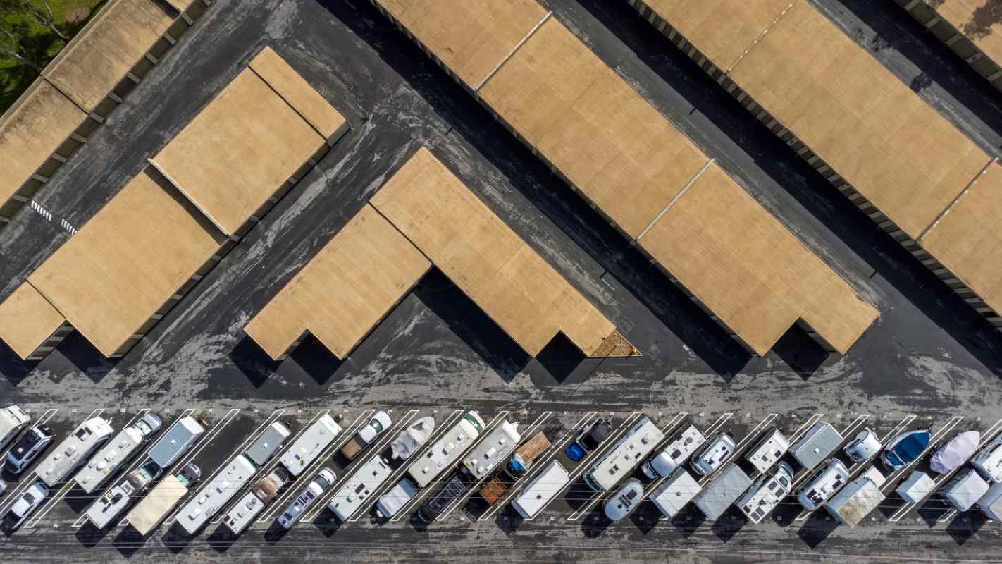 A bird’s-eye view of a self storage facility with a row of outdoor RV parking.