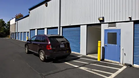 Outdoor storage units and a car at Self Storage Plus on 45601 Woodland Road.