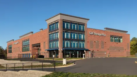 Self Storage Plus red brick building from a distant view.