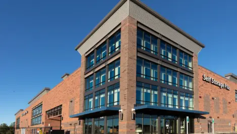 Self Storage Plus red brick building from a front view angle.