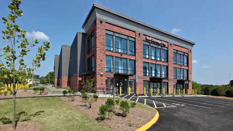 Self Storage Plus red brick building with pristine landscaping.