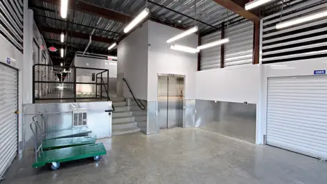 Indoor storage facility with elevator and carts to help move boxes.