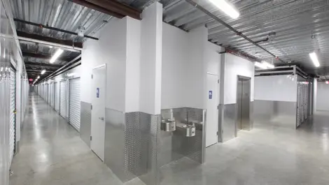 Clean indoor storage facility with water fountains and an elevator.