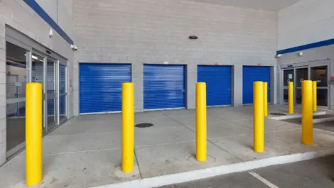 Storage units attached to the building with the overhead of the building to block rain and sun.