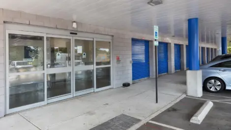 Front sliding doors to storage facility office with handicapped parking.