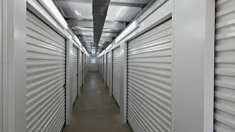 Indoor storage units from a hallway view.