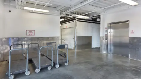 Inside view of storage facilities elevator and moving carts.