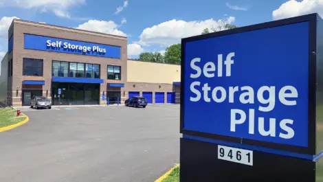 Self Storage Plus sign with building in the background.