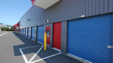 Red door leading to inside storage facility building.