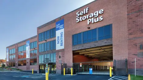 Self Storage Plus with gated access into the right side of the building.