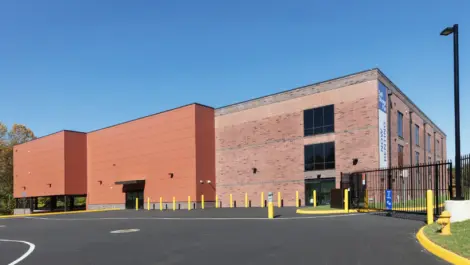 Back of storage facility showing another gated access.