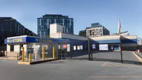 U-store facility with apartments and tall building in the back.