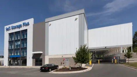 Front view of Self Storage Plus white building.