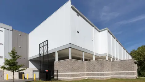 Opened security gate with brick walls outlining the perimeter of the storage facilty.