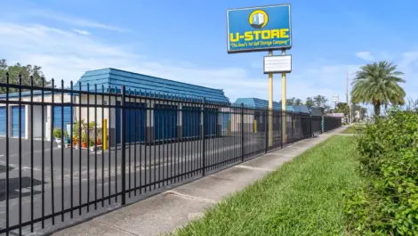 U-Store sign in front of gated storage units.