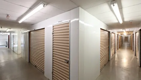 Indoor storage units with tan doors.