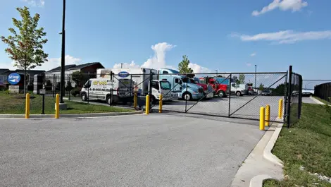 Image of vehicle and truck parking secured by security gate.