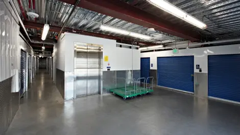 Indoor storage unit elevator with buggies.