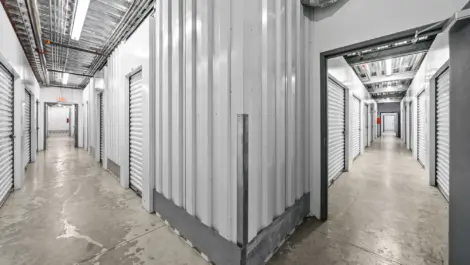 Hallway view from corner showing two sections of indoor storage units.