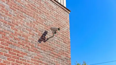 Security camera on a brick wall.