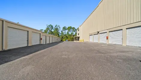 Paved road to tan storage units.