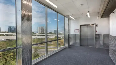 View looking out the window towards the highway by an elevator at Self Storage Plus - Tysons.