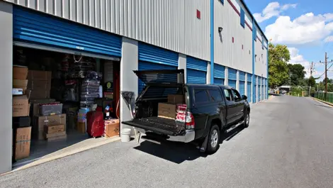 Self Storage Plus White Oak drive-up storage units with a car in front.